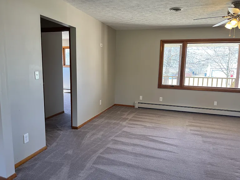 Kitchen to living room and hallway to second bedroom