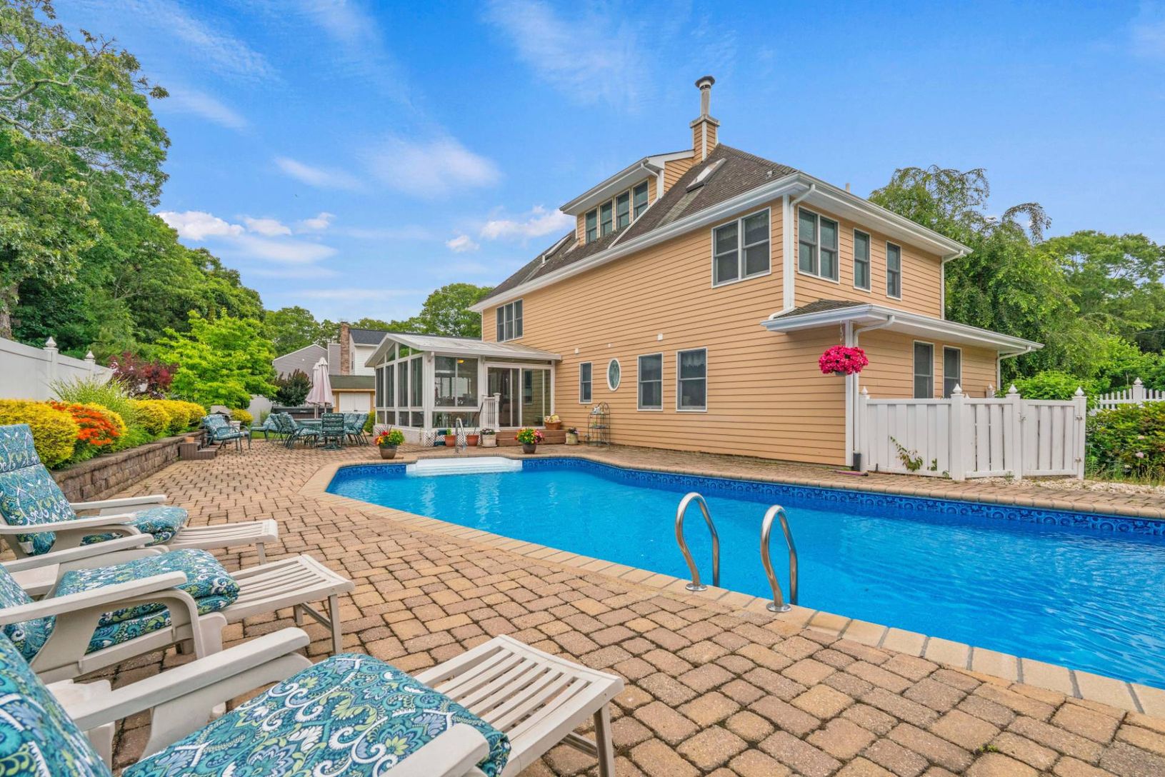Sunsoaked heated pool with waterfall