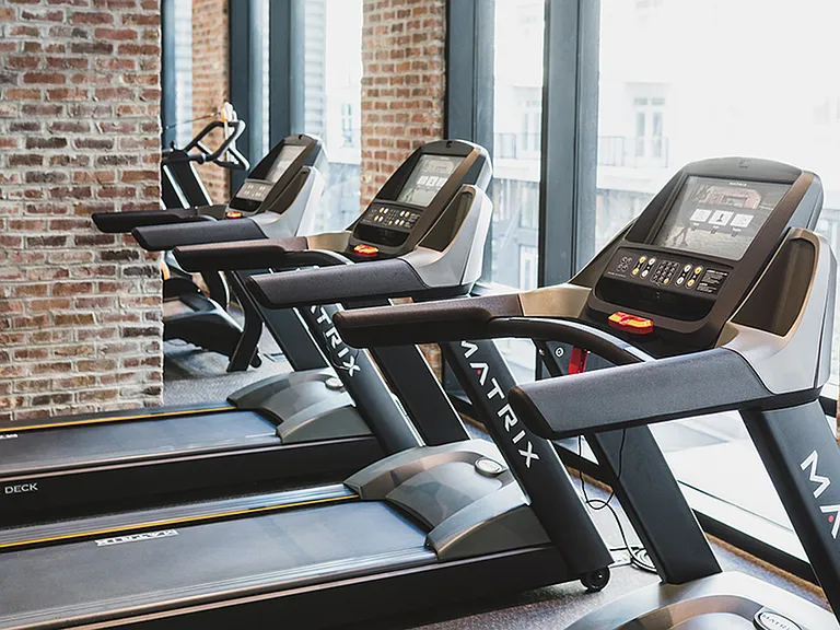Fitness center with treadmill with cardio theatre