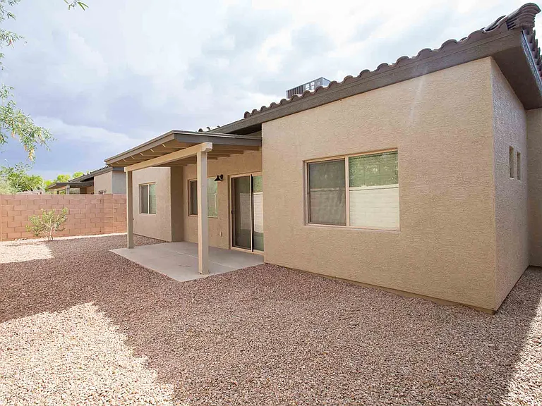 Private low maintenance backyard with covered patio and mountain views.