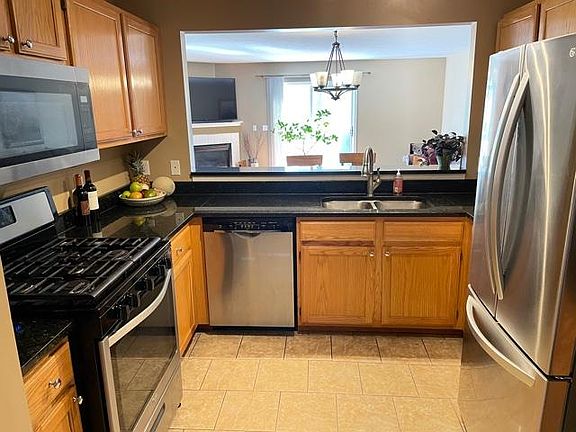 Kitchen with granite counters and open bar and all newer stainless steel appliances