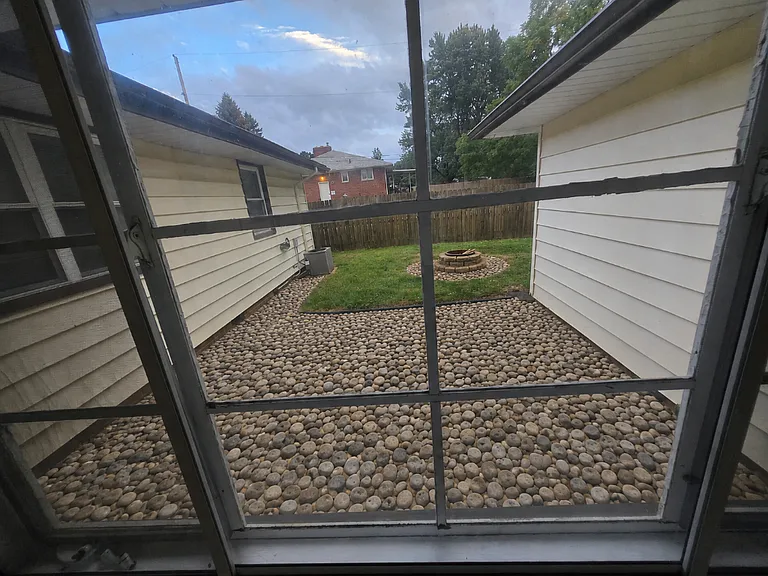 breezeway leads to backyard outdoor space with firepit