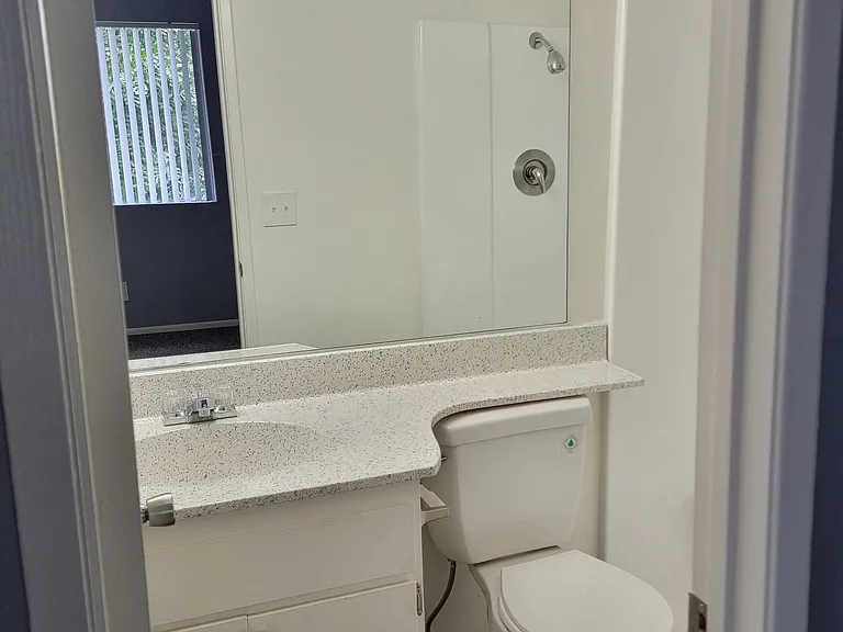 Bathroom with tub and shower at Grand Oaks Apartments in Lake Elsinore, California.