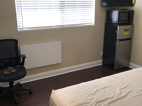 studio style bedroom with fridge/microwave