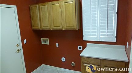 Laundry with 2 rows of cabinets and folding counter