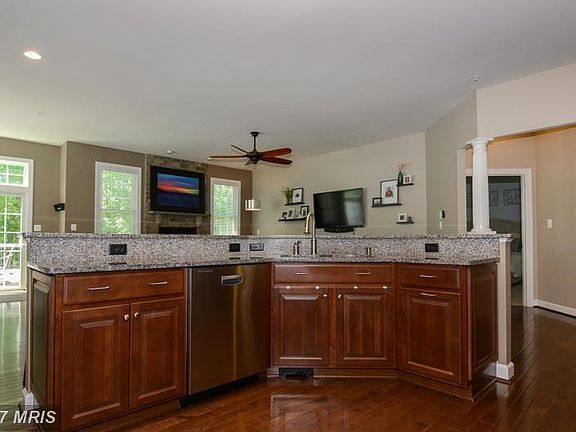 Island with granite counter and cherry cabinets