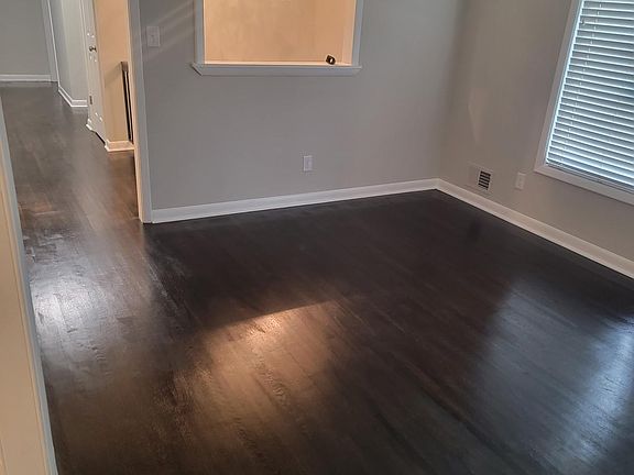 View of top floor living room breezeway to bedrooms and bathrooms