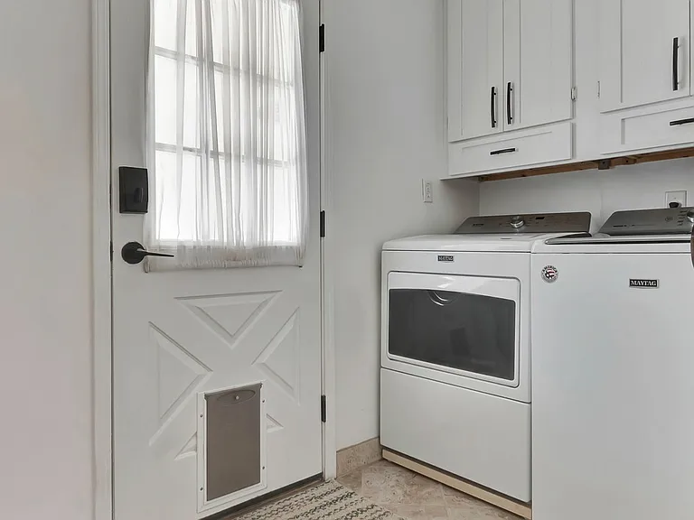 laundry room , door leads to backyard/garage area