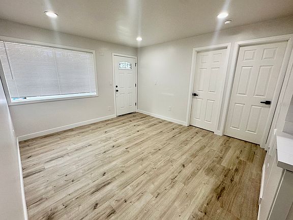Entry into living room with new paint, doors, flooring, and more. Both doors to bedroom are solid core with brand new hardware.