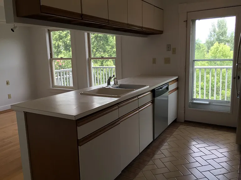 Open Floor Plan between Kitchen and Dining Room. Kitchen has tile floor, Dining Room hardwood floor.