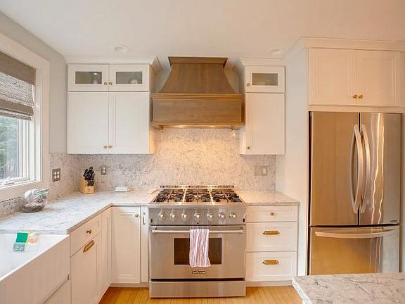 Newly renovated kitchen with industrial stove and hood.