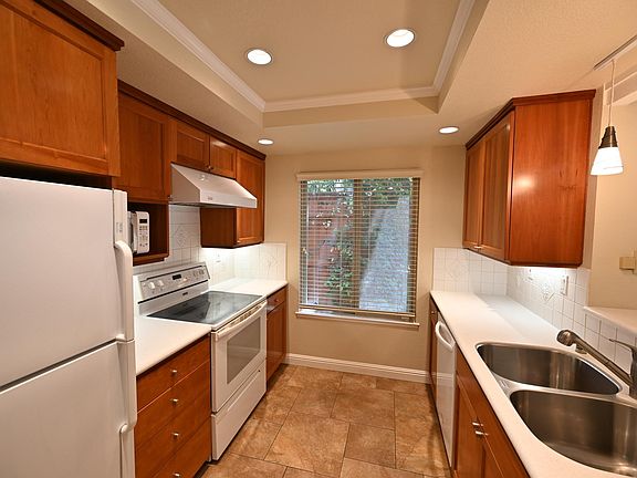 Kitchen view. Stainless steel double sink. Ceramic cooktop on Jenn-Air stove. Custom cherry cabinets. Microwave. Recessed lighting. Kitchen Aid dishwasher. Frigidaire refrigerator. Kinetico RO drinking water system at sink.