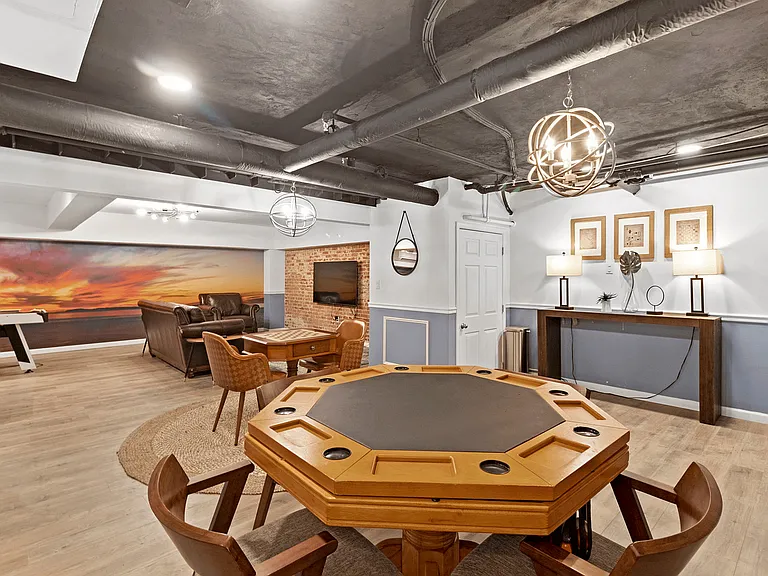 Experience luxury living with this beautifully designed basement lounge, perfect for relaxation and entertainment.