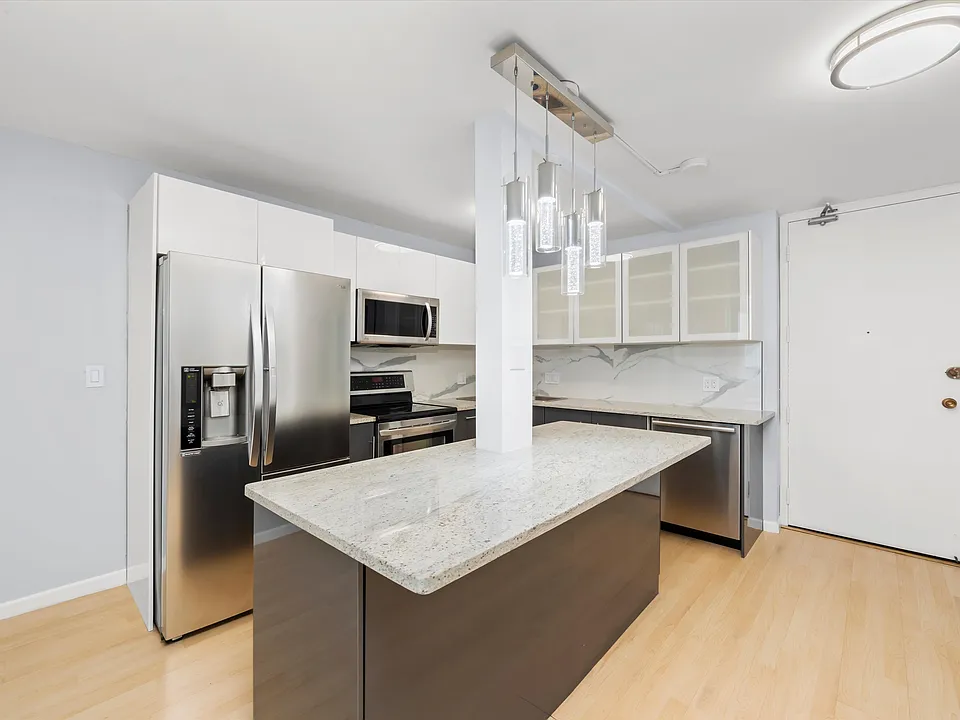 Open kitchen layout, modern open kitchen design, including dishwasher, range, microwave, and refrigerator