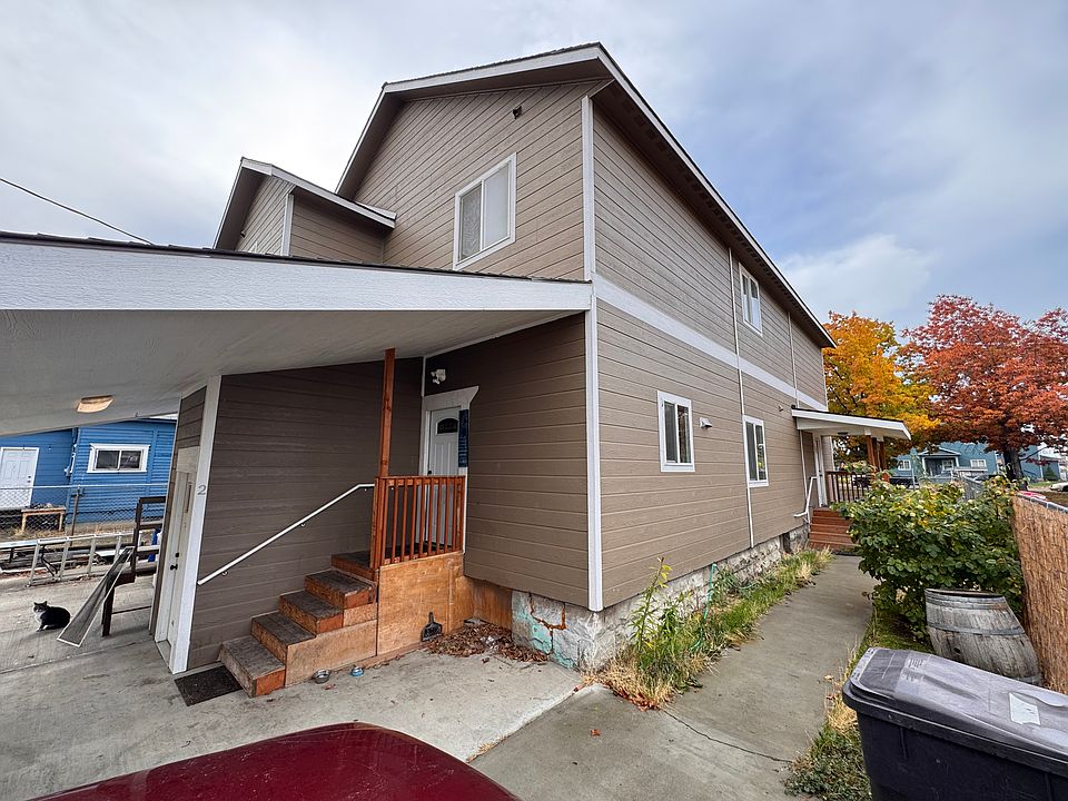 Main entrance at the rear of the duplex; designated parking is also on this side of the building