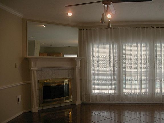 Den area with fireplace and large windows!
