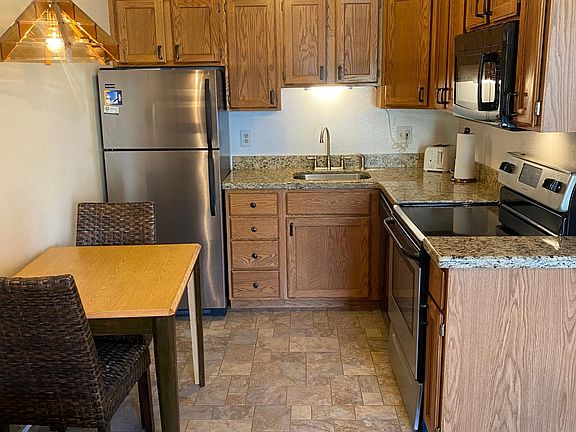 Full kitchen with full sized fridge, oven, dishwasher and appliances