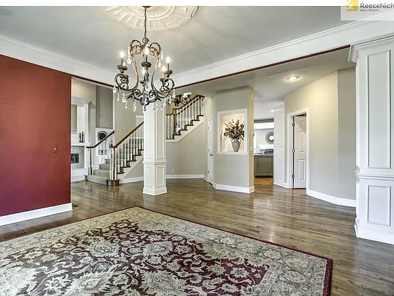 Large open dining room with gleaming wood floors an updated lighting