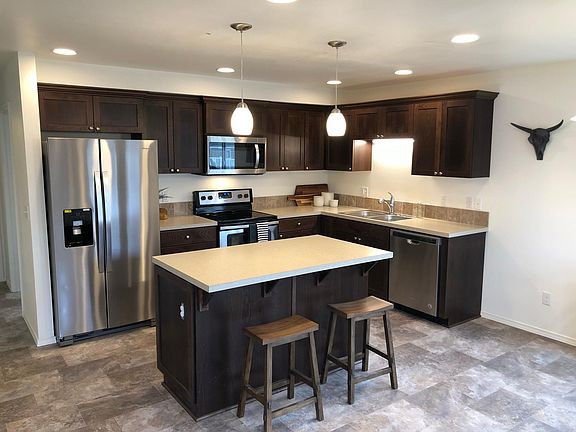 Stainless appliances and island in every kitchen.