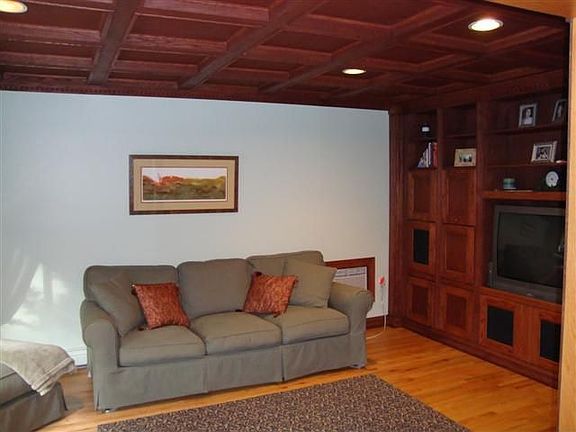 Family room has coffered ceiling & built ins.
