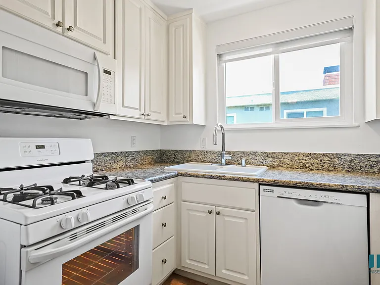 Kitchen with Refrigerator, Stove, and Microwave Oven