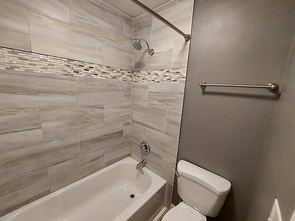Full surround tile to the ceiling, tub, and shower.