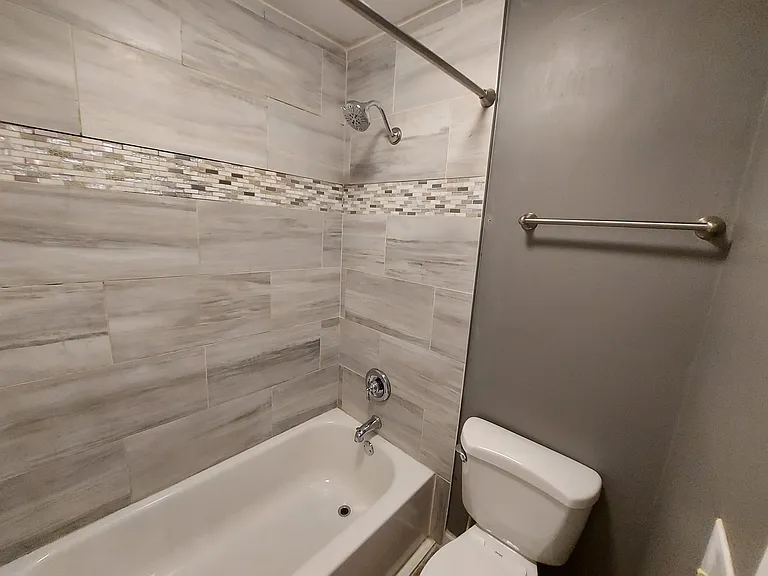 Full surround tile to the ceiling, tub, and shower.