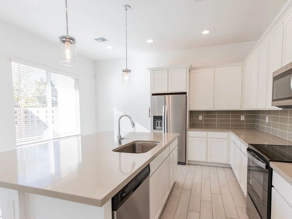 Another angle of the kitchen before it was occupied. As you can see, there are TONS of cabinets, counter space and room for cooking accoutrements. Out of view of this image to the right is a large pantry closet.