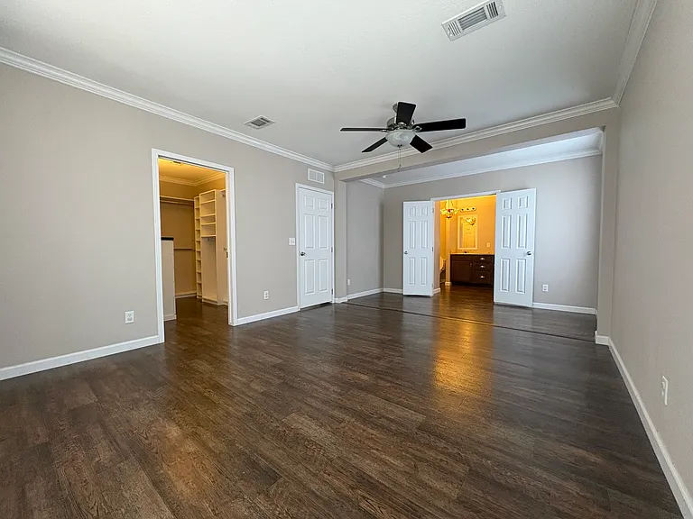 master bedroom with master closet on left and master bathroom on right. door in middle leads out to the living room