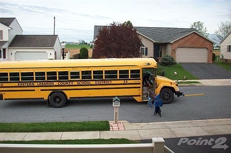 School bus stop in front of house