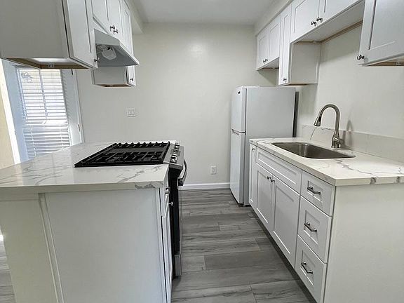 Kitchen. New range, cabinets, countertops, faucet, sink. 
(refrigerator will be replaced)