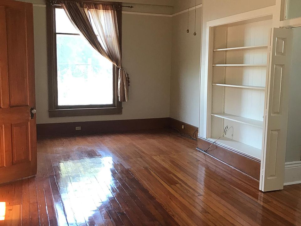 From apartment entry door, living room. Door on the left is to huge closet/storage above entry staircase. Bifold door on the right is to bedroom 1.