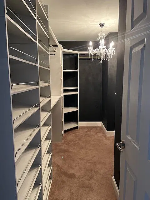 The oversized primary suite is a standout visual feature, showcasing an expansive bedroom design. It comes complete with a massive, custom-built master walk-in closet and a spacious ensuite bathroom for a true private retreat.