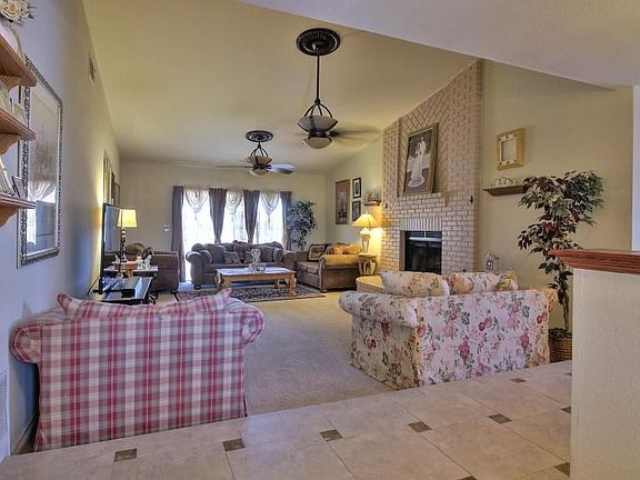 Sunken living room with floor to ceiling fireplace and sliding door to pool. Room is 23'x15'.