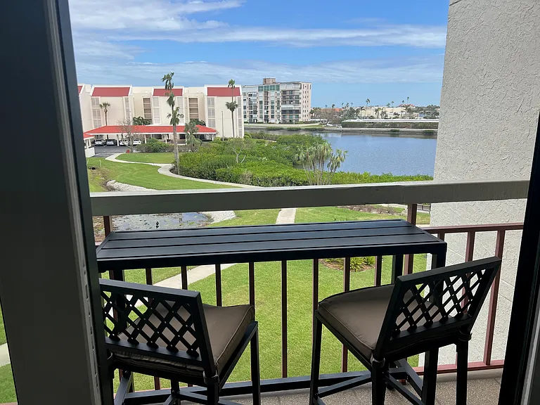 View from living room balcony with table and chairs