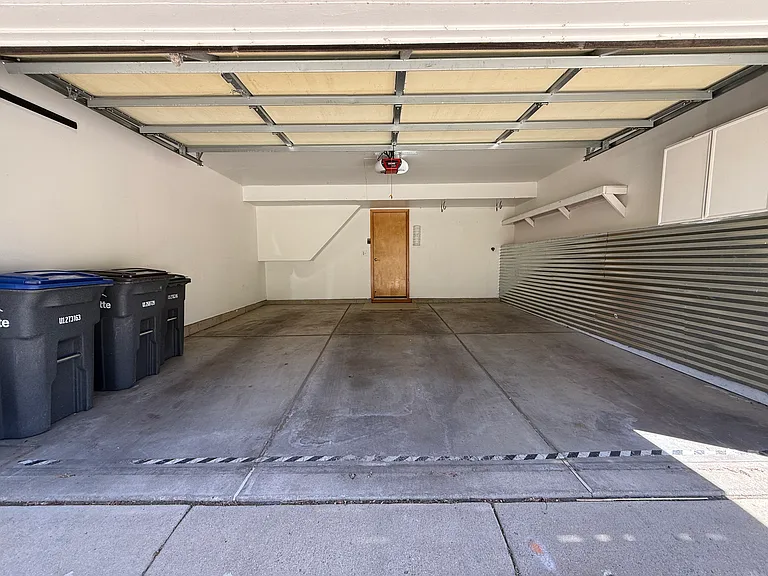 Attached two-car garage with storage shelving