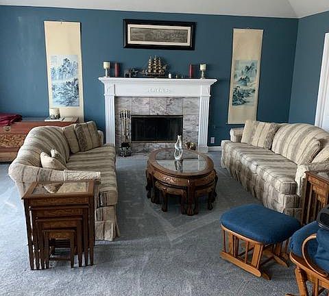 Living room with gas fireplace. Doors, barely seen, on the right lead to the formal dining room. Large bay window with seating area, unseen, on the left.