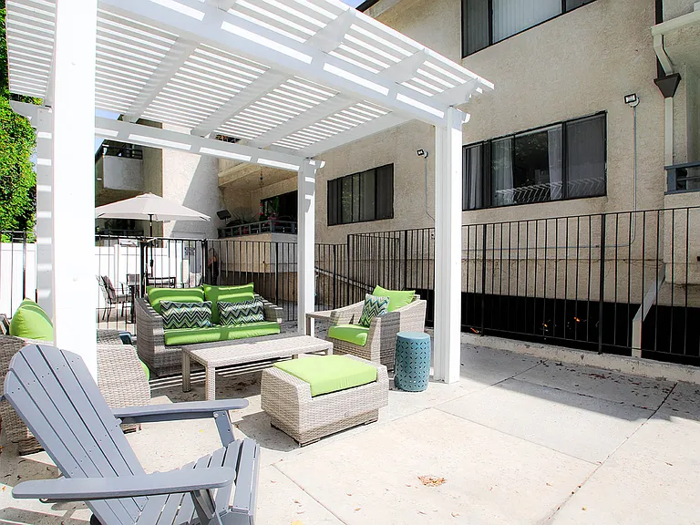 Community barbecue area with seating and lounging space.