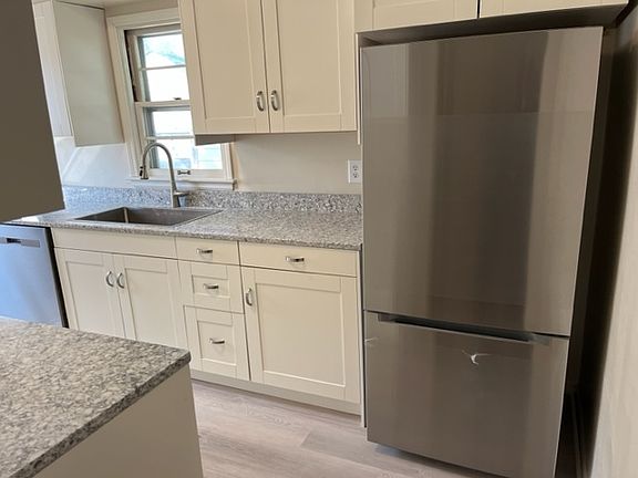 Kitchen with newer cabinets, tops, and SS appliances