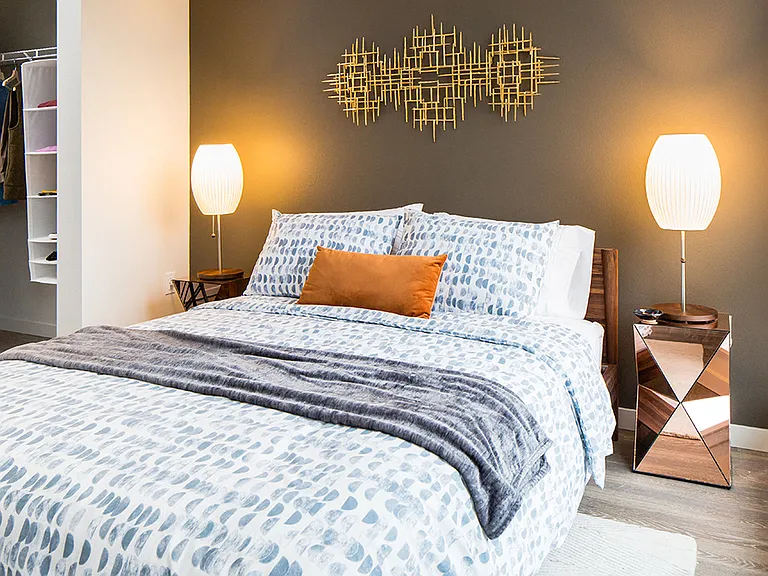 Bedroom with large windows and chic decor for a vibrant look.