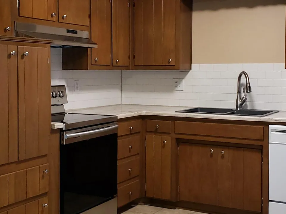 Kitchen with New Counter tops, Glass top Range and Faucet