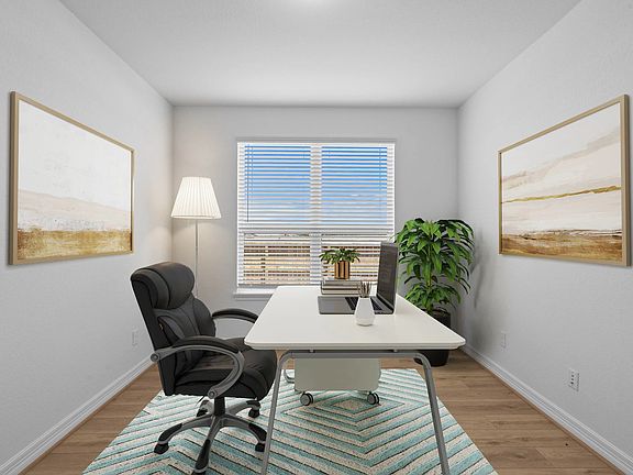 The home office features French doors, beautiful floors, large windows that give a fresh feel, this