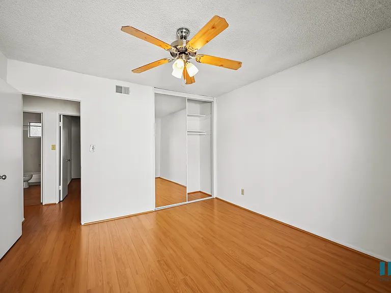 Bedroom with a Closet, Ceiling Fan, and Vinyl Flooring