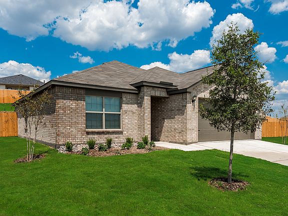 Enjoy a stunning brick exterior and professional front yard landscaping.