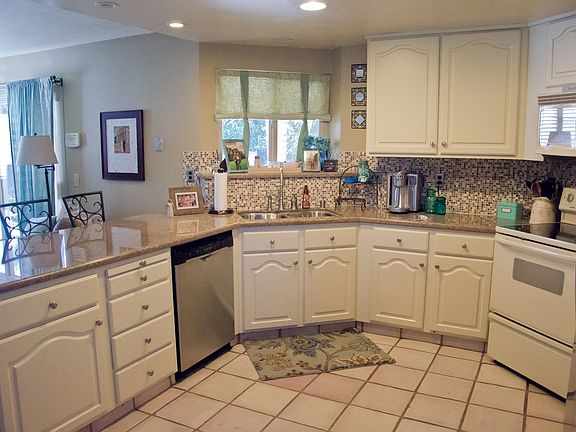 Kitchen features granite counters, tile backsplash, stainless steel appliances