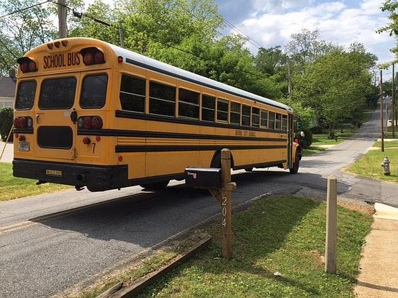 School bus stops in front of house