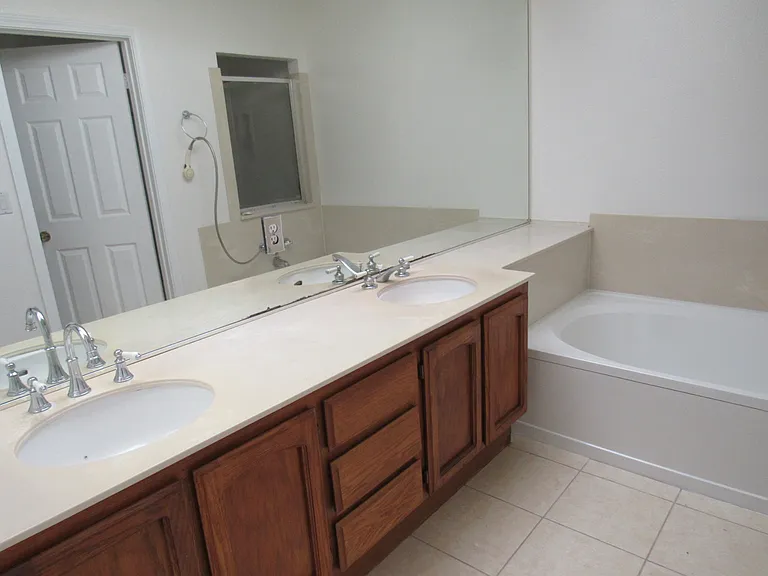 Master bath with his and hers sinks and tub