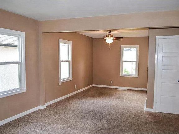 Spacious living room with lots of windows and natural light.