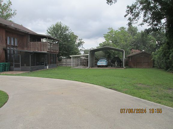 rear yard showing three (3) concrete pads with covered parking-- GREAT for Boats, travel trailers, and TOYS!
