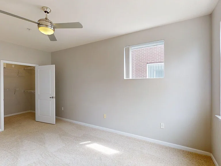 Spacious apartment Bedroom with Large Closet and Carpet.
